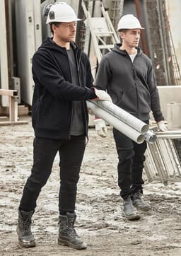 Unisex zip front multi-pocket hoodie in black, worn by two men on a construction site, carrying pipes. Both wear hard hats.