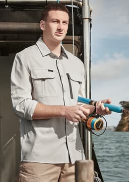 A light grey long sleeve button-up shirt with two chest pockets, worn by a man holding a fishing rod by the water.