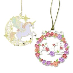 Two decorative ornaments: one featuring a unicorn in a gold and pastel design, the other a floral wreath in vibrant colours.