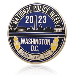 A round hard enamel coin featuring a blue and gold design with a cityscape, text, and an emblem at the bottom.
