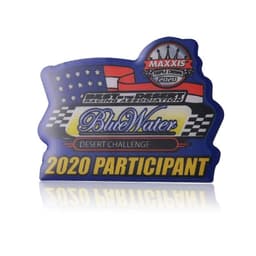 A blue enamel lapel pin with a racing theme, featuring a logo and the text "2020 Participant" in yellow.