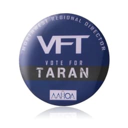 A round pin featuring a blue background with white and black text and a logo.