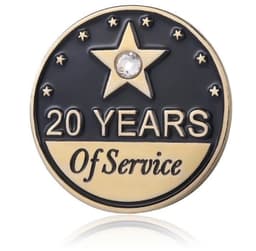 A brass lapel pin featuring a star, commemorating "20 Years of Service" with a clear gem accent.