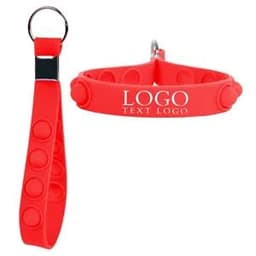 A red silicone keychain featuring a push pop stress reliever design and a logo.