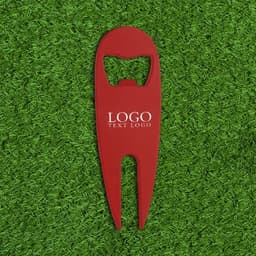 A drink bottle opener and divot repair tool in red, featuring a logo, set against a green grass background.