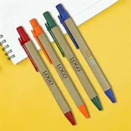 A set of four eco-friendly ballpoint pens in red, green, orange, and blue with a logo on their barrels.