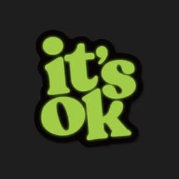 A glowing green sticker with the text "it's OK" on a dark background.