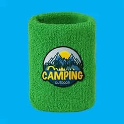 A green terry sweatband wristband featuring a woven logo with a mountain and sun design.