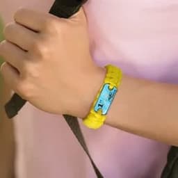 A yellow paracord survival bracelet with a blue buckle, worn on a wrist.
