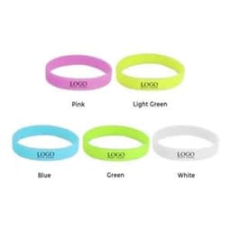 A selection of glow-in-the-dark silicone bracelets in pink, light green, blue, green, and white, each with a logo.