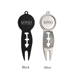 A golf divot repair tool in black and silver, featuring a ball marker and a logo.
