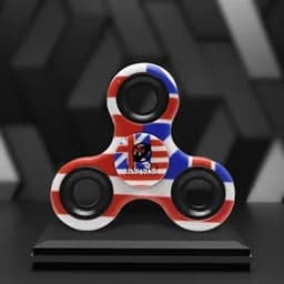 A hand finger spinner featuring a red, white, and blue design, displayed on a black pedestal.