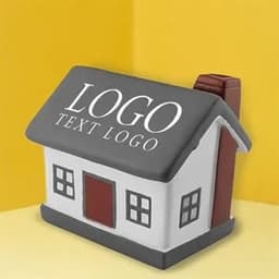 A house-shaped stress ball in white and grey, featuring a red door and a chimney, with a logo on the front.