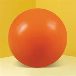 An orange round stress ball with a glossy finish, set against a yellow background.