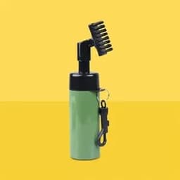 A green bottle with a black spray nozzle and brush attachment, featuring a keychain clip.