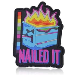 A colourful 2D PVC patch featuring a flaming pizza box with the text "NAILED IT," set against a black background.