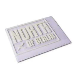 A white 3D silicone patch featuring the words "NORTH of BERLIN" in raised lettering on a textured background.