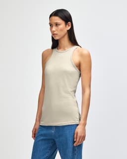 A light beige women’s racerneck tank top with a fitted design and a logo. Ideal for casual wear.