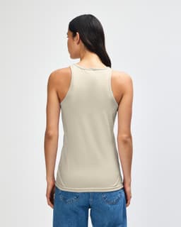 A women's racerneck tank in beige, featuring a logo on the back and a fitted silhouette.