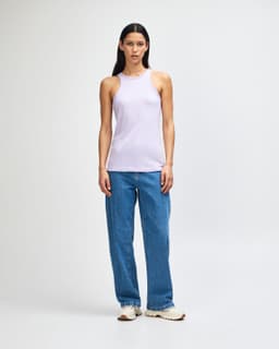 A lilac women's racerneck tank top paired with loose blue jeans, featuring a simple design and no visible logos.