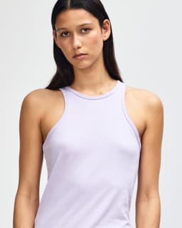 A light purple women's racerneck tank top with a fitted style and a branding logo.