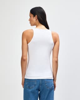 A white women's racerneck tank top, featuring a fitted design and a logo on the back.