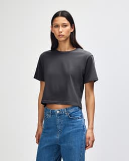 A grey women's boxy T-shirt with a relaxed fit, featuring short sleeves and a simple design.