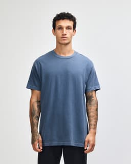 A unisex heavyweight cotton t-shirt in navy blue, featuring short sleeves and a simple design. It has a logo.