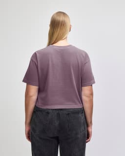 A heavy cotton women's crop boxy t-shirt in a muted mauve colour, featuring a simple design and a logo.