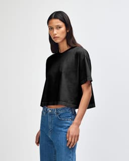 A black heavyweight cotton women's crop boxy T-shirt displayed on a model, featuring a relaxed fit.