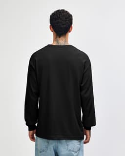 A black heavyweight cotton unisex long sleeve t-shirt viewed from the back, worn with olive green pants.