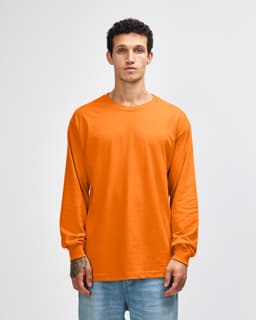 An orange heavyweight cotton unisex long sleeve t-shirt displayed on a model, featuring a logo.