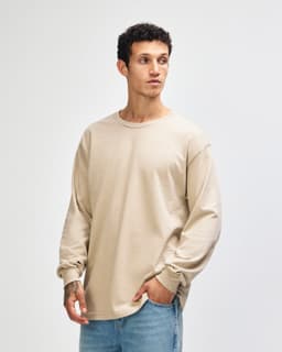A beige heavyweight cotton unisex long sleeve T-shirt, featuring a rounded neckline and long sleeves.