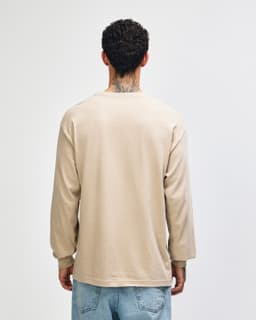 A heavyweight cotton unisex long sleeve T-shirt in beige, featuring a simple design and a branding logo.