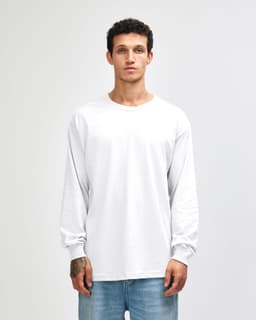 A heavyweight cotton unisex long sleeve T-shirt in white, displayed on a model with straight black hair.