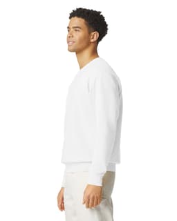 A white crewneck sweatshirt displayed on a model, featuring a logo and a relaxed fit.