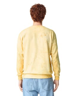 A yellow crewneck sweatshirt with a distressed look, featuring a logo on the back.