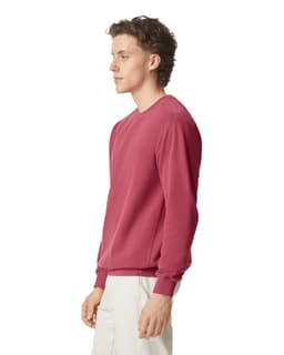 A maroon adult crewneck sweatshirt displayed on a model from the side, featuring long sleeves and a fitted design.