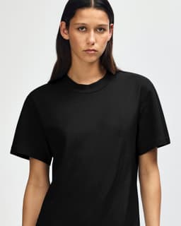 A black unisex mockneck t-shirt with short sleeves, featuring a logo on the front.