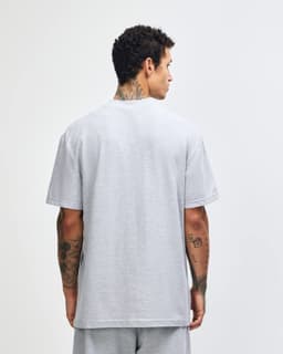 A grey unisex pique mockneck T-shirt displayed from the back. Features short sleeves and a logo.