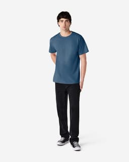 A model wearing a blue Gildan Ultra Cotton adult T-shirt paired with black pants and sneakers.