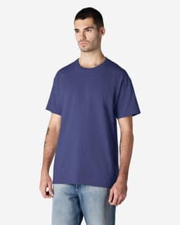 A navy Gildan Ultra Cotton adult t-shirt on a model, featuring a simple design and a logo.