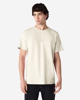 A light cream Gildan Ultra Cotton adult T-shirt on a model, featuring short sleeves and a round neckline.