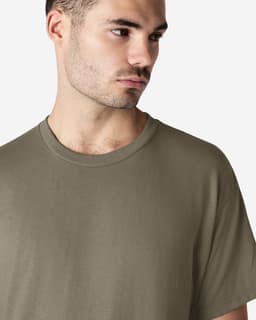 A model wearing a khaki Gildan Ultra Cotton adult t-shirt, featuring a round neckline and short sleeves.