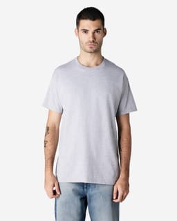 A grey Gildan Ultra Cotton adult T-shirt displayed by a model wearing blue jeans, featuring a plain design and a logo.