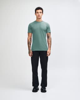 A unisex fine jersey short sleeve t-shirt in teal, paired with beige cargo pants, worn by a model.
