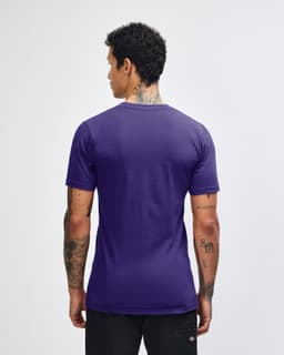 A purple unisex short sleeve t-shirt, featuring a logo, displayed from the back on a model.