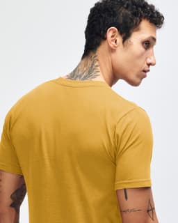 A mustard yellow short sleeve t-shirt featuring a crew neck and a subtle logo on the back.
