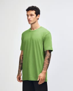 A green unisex short sleeve t-shirt displayed on a model from the side, featuring a branding logo.