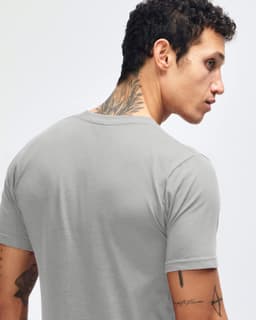 A grey fine jersey short sleeve t-shirt featured on a person from the back, showcasing the garment's fit and style.